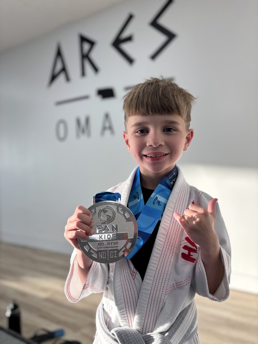Young Ares BJJ Omaha student with his tournament medal