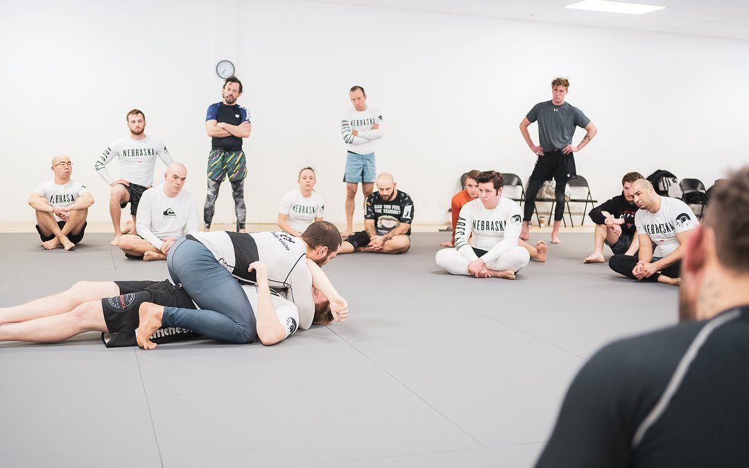 Instructor demonstrating a technique to the adult class at Ares BJJ Omaha