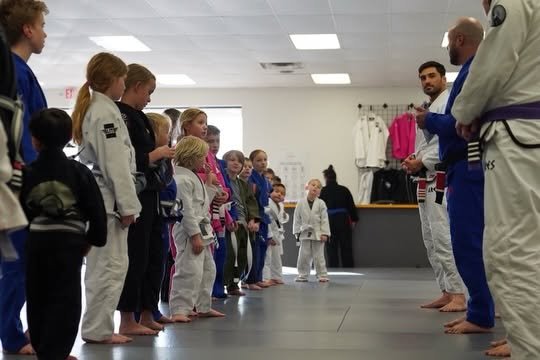 Kids lined up facing instructors at Ares BJJ Omaha